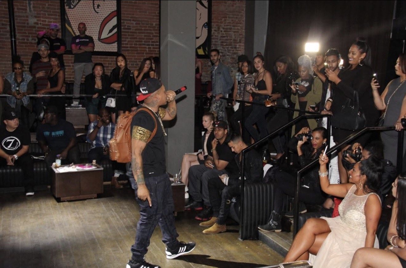 Antidote performing to a packed room, crowd filming